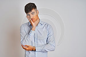 Young indian businessman wearing elegant shirt standing over isolated white background thinking looking tired and bored with