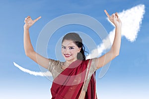 Young Indian businesswoman with upward arrow