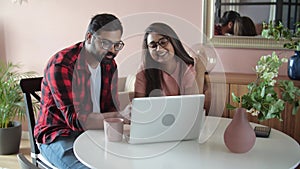 Young indian couple chatting with relatives via videoconference videocall application. Distant virtual communication