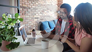 Young indian couple chatting with relatives via videoconference videocall application. Distant virtual communication