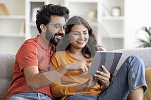 Young Indian Couple Shopping Online On Digital Tablet At Home
