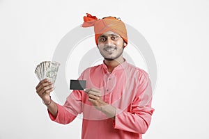 Young Indian farmer posing with currency on white background
