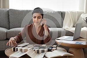 Young indian female choose stone dalle samples for home decoration