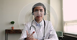 Young indian general practitioner holding video call.