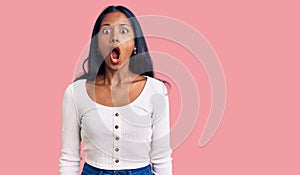 Young indian girl wearing casual clothes afraid and shocked with surprise expression, fear and excited face