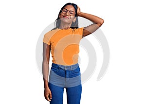 Young indian girl wearing casual clothes and glasses confuse and wonder about question