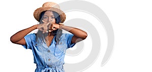 Young indian girl wearing summer hat rejection expression crossing fingers doing negative sign