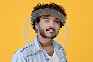 Young indian guy isolated on yellow background, headshot close up portrait.