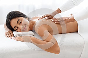 Young Indian Lady Getting Mineral Salt Scrub In Spa
