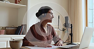 Young Indian lady in headset make podcast using professional microphone