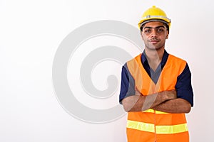 Young Indian man construction worker against white background