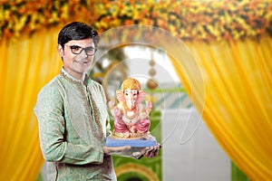 Young Indian man with Lord Ganesha , Celebrating Ganesh festival