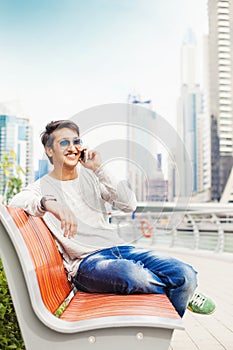 Young indian man relaxing on a bench