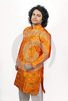 Young indian model wearing orange kurta