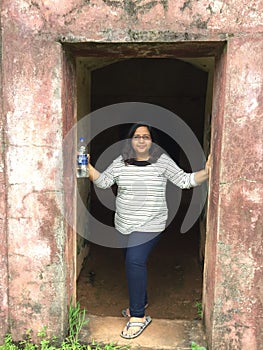 A young Indian woman posing gracefully at an entrance