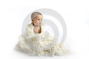 A Young Infant Sitting on a White Background