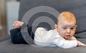 Young infant smiles and plays on his playmat