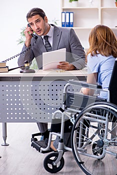 Young injured woman and male lawyer in the courtroom