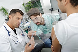 Young internist student learning with experienced doctor photo