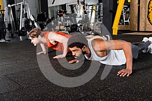 young interracial sportsmen doing push ups