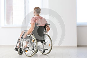 Young invalid man in empty room