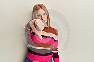 Young irish woman wearing casual clothes looking unhappy and angry showing rejection and negative with thumbs down gesture