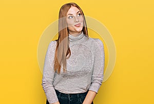 Young irish woman wearing casual clothes smiling looking to the side and staring away thinking