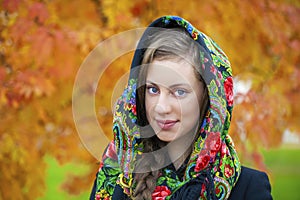 Young Italians in coat and knit a scarf on her head photo