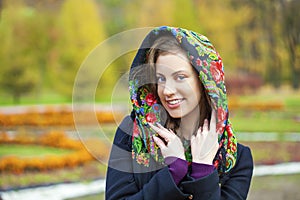 Young Italians in coat and knit a scarf on her head photo