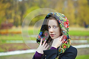 Young Italians in coat and knit a scarf on her head photo