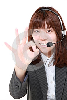 Young Japanese businesswoman of call center with head setsã€€ showing perfect sign