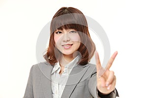 Young Japanese woman showing a victory sign