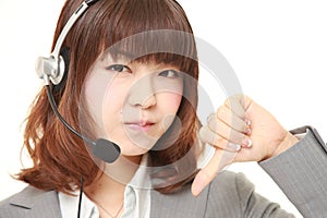 Young Japanese businesswoman with thumbs down gesture