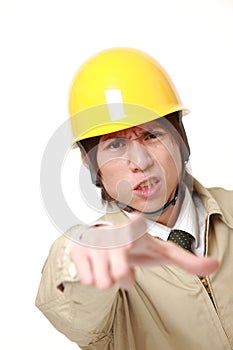 Young Japanese construction worker scolding