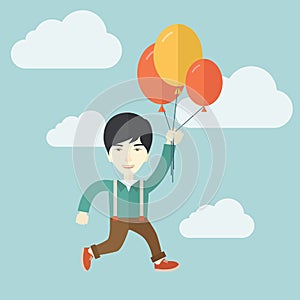 Young japanese man flying with balloons