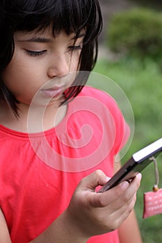 Young Japanese-Russian girl playing with cellphone