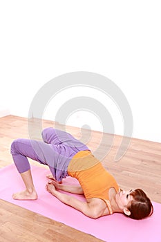 Young Japanese woman doing YOGA bridge pose