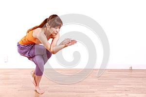 Young Japanese Woman Doing YOGA eagle pose