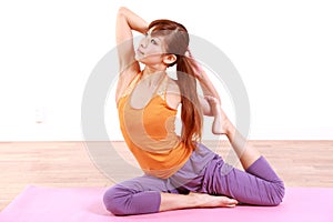 Young Japanese woman doing YOGA plow pose