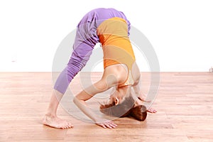 Young Japanese Woman Doing YOGA wide legged forward bend pose
