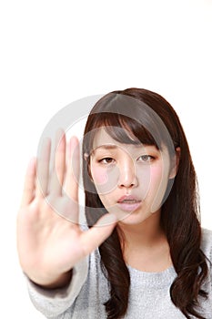 Young Japanese woman making stop gesture