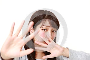 Young Japanese woman making stop gesture