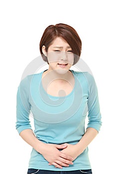 Young Japanese woman suffers from stomachache