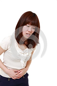 Young Japanese woman suffers from stomachache