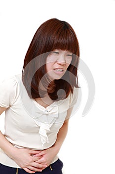 Young Japanese woman suffers from stomachache
