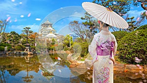 Young Japanese Woman in a Traditional Kimono Dress at Osaka Castle in Osaka, Japan