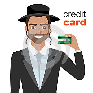 Young jew man smiling, showing, presenting credit card for making paymen.