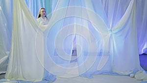 Young Jewish bride rehearsing an exit under the chuppah before the wedding