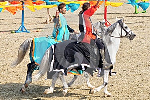 Young knights horseback riding on purebred horses