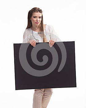 Young jocose woman showing presentation, pointing on placard
